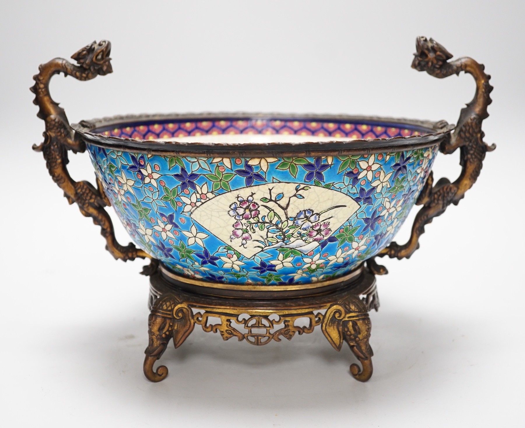 A 19th century French Longwy style ormolu mounted faience bowl on ornate dragon design stand, 23cm high